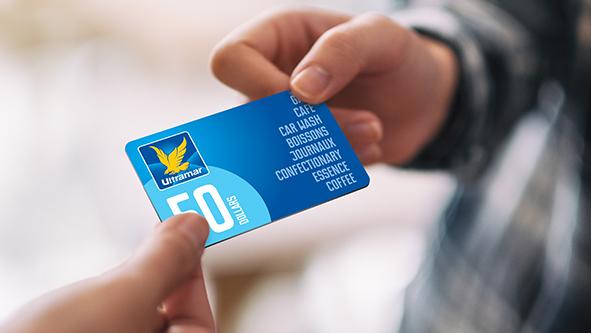 Hands holding an Ultramar gift card.